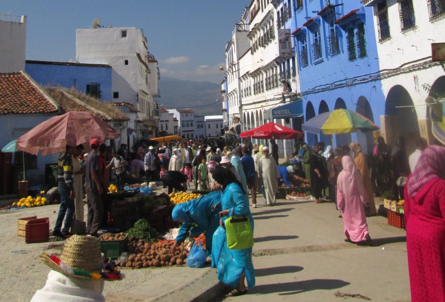 Women at a market in Chefchaouen, Morocco wearing djellabas